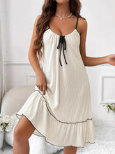 Woman wearing Tiered Ruffled Lounge Dress with contrast trim and drawstring waist, showcasing feminine style and comfort.