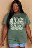 Woman wearing a Graphic Cotton T-Shirt with 'CREATE HAPPINESS' print, showcasing uplifting style and comfort in a casual look.