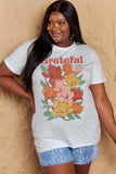 Woman wearing a Graphic Cotton T-Shirt with 'GRATEFUL' flower print for a casual look