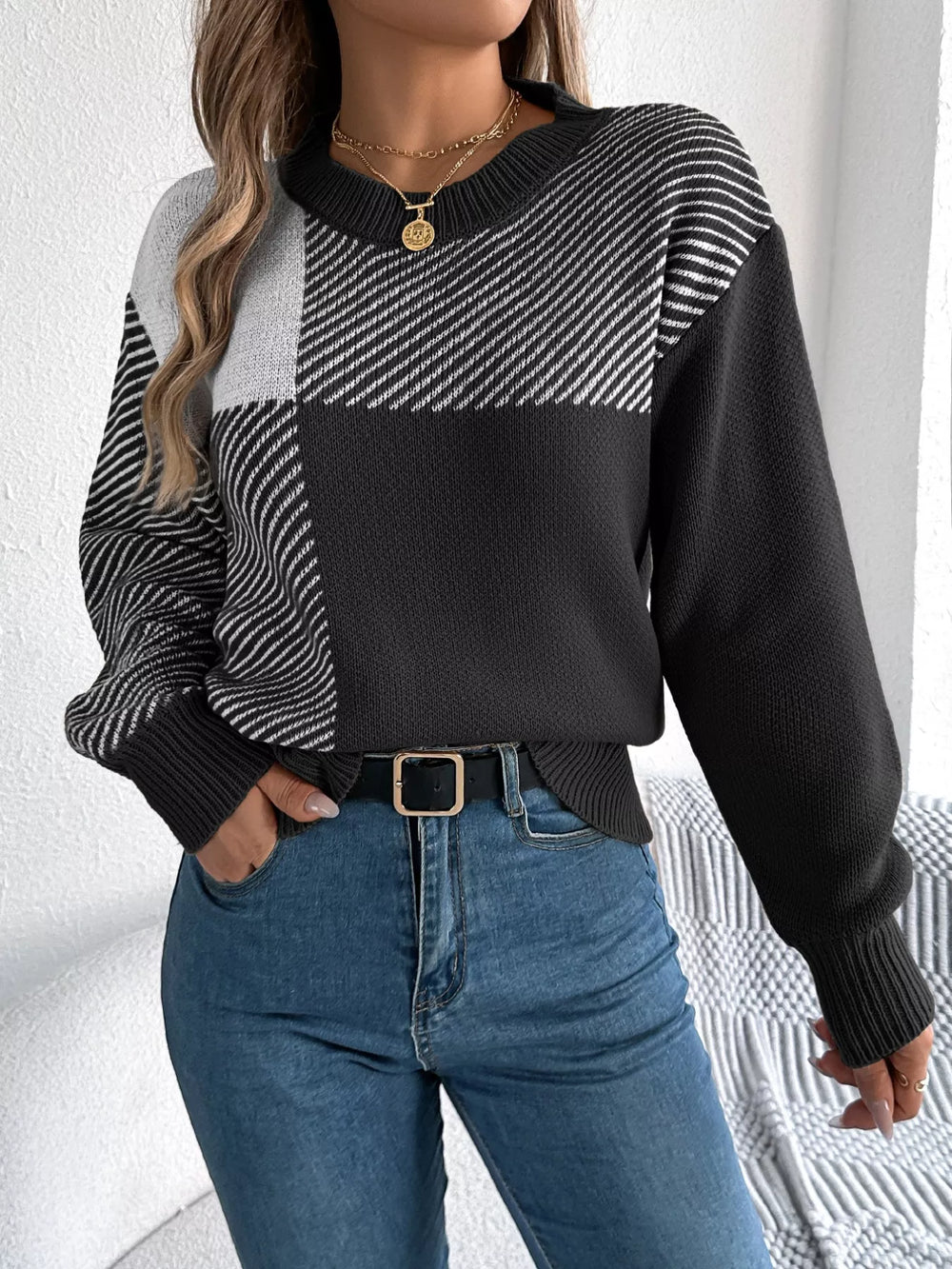 Color Block Striped Sweater with round neck and bold pattern, perfect for a modern casual look, worn with jeans for cozy sophistication.