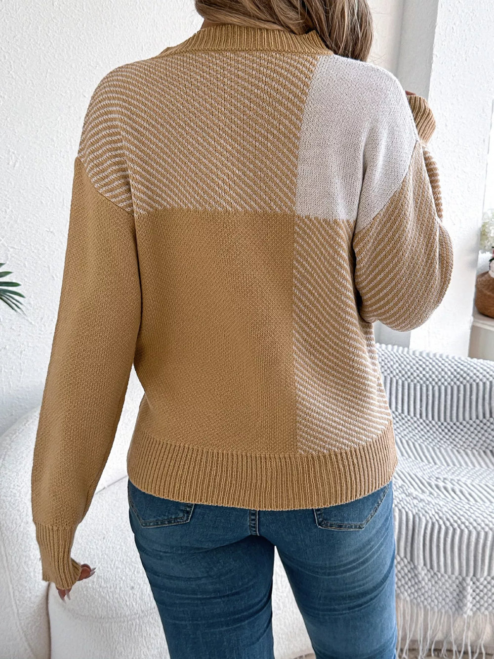 Back view of a Color Block Striped Sweater with a round neck, showcasing the bold color block striped design in a cozy knit style.