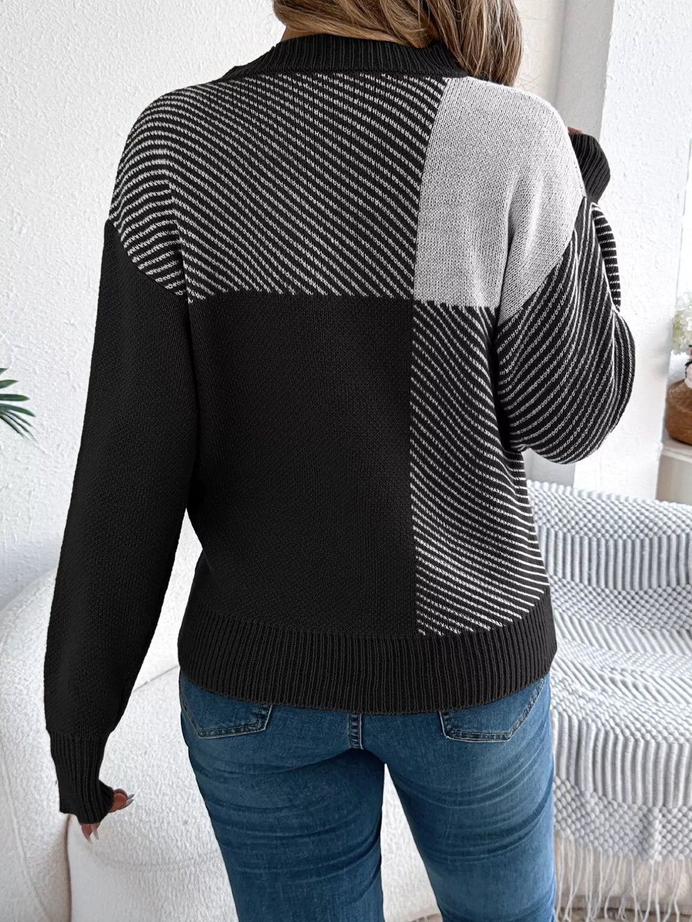 Back view of Color Block Striped Sweater with round neckline in black and grey pattern.