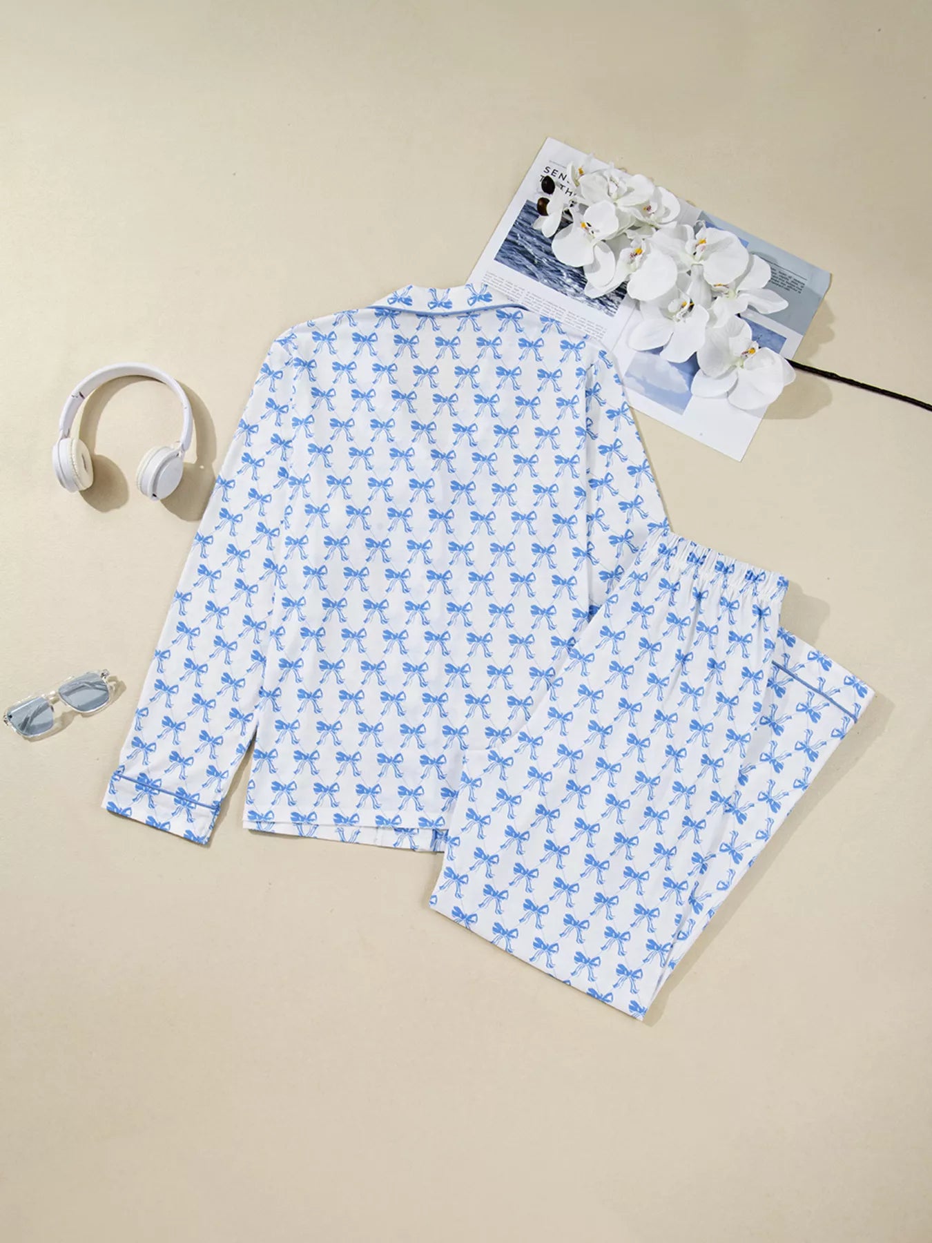 Bow Print Pajama Set by Felvior featuring long sleeve shirt and pants with blue bows on a white background.
