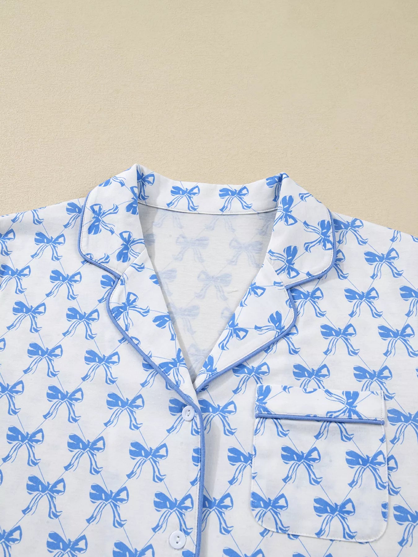 Bow Print Pajama Set long sleeve shirt with blue bows from Felvior, showcasing button detail and comfortable design.