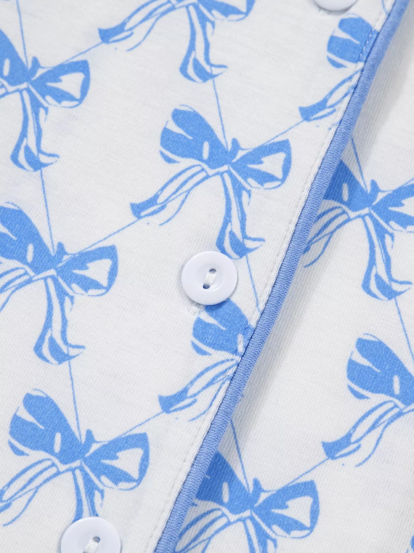 Close-up of Bow Print Pajama Set fabric with button details by Felvior