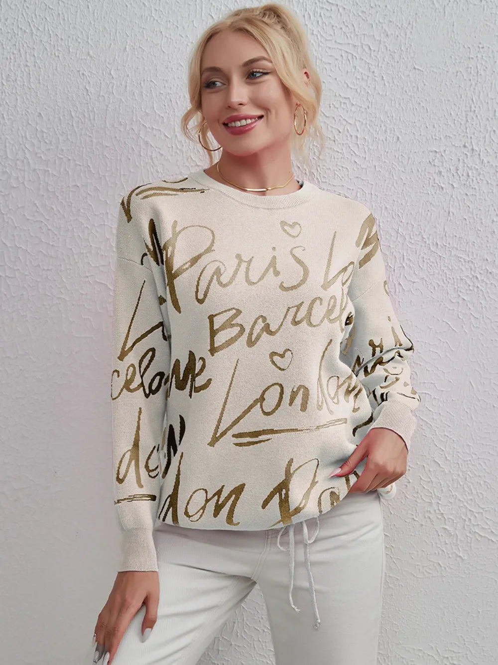 Woman wearing a Letter Pattern Sweater with drawstring hem and dropped shoulders, showcasing stylish comfort and unique design.