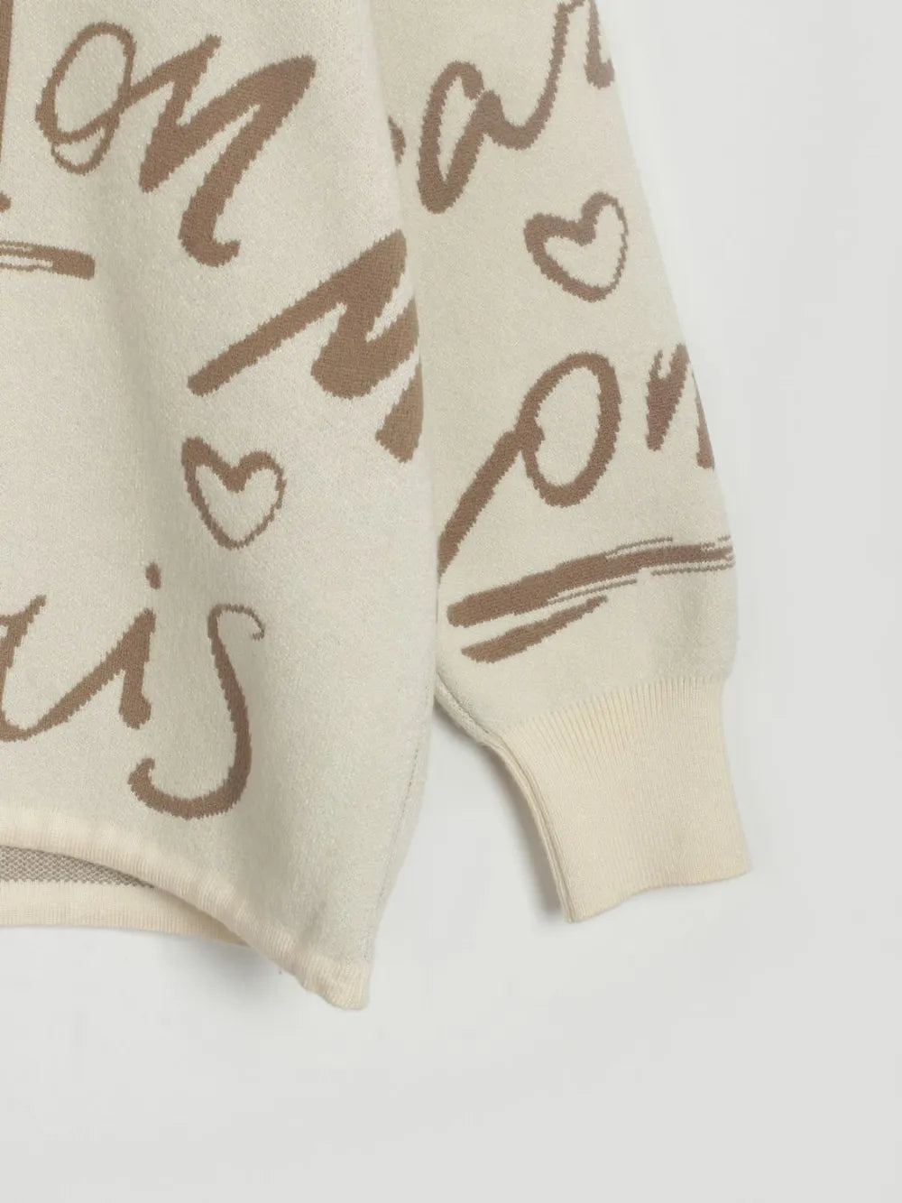 Close-up of Letter Pattern Sweater with drawstring hem and dropped shoulder design, featuring a heart pattern for a playful twist.
