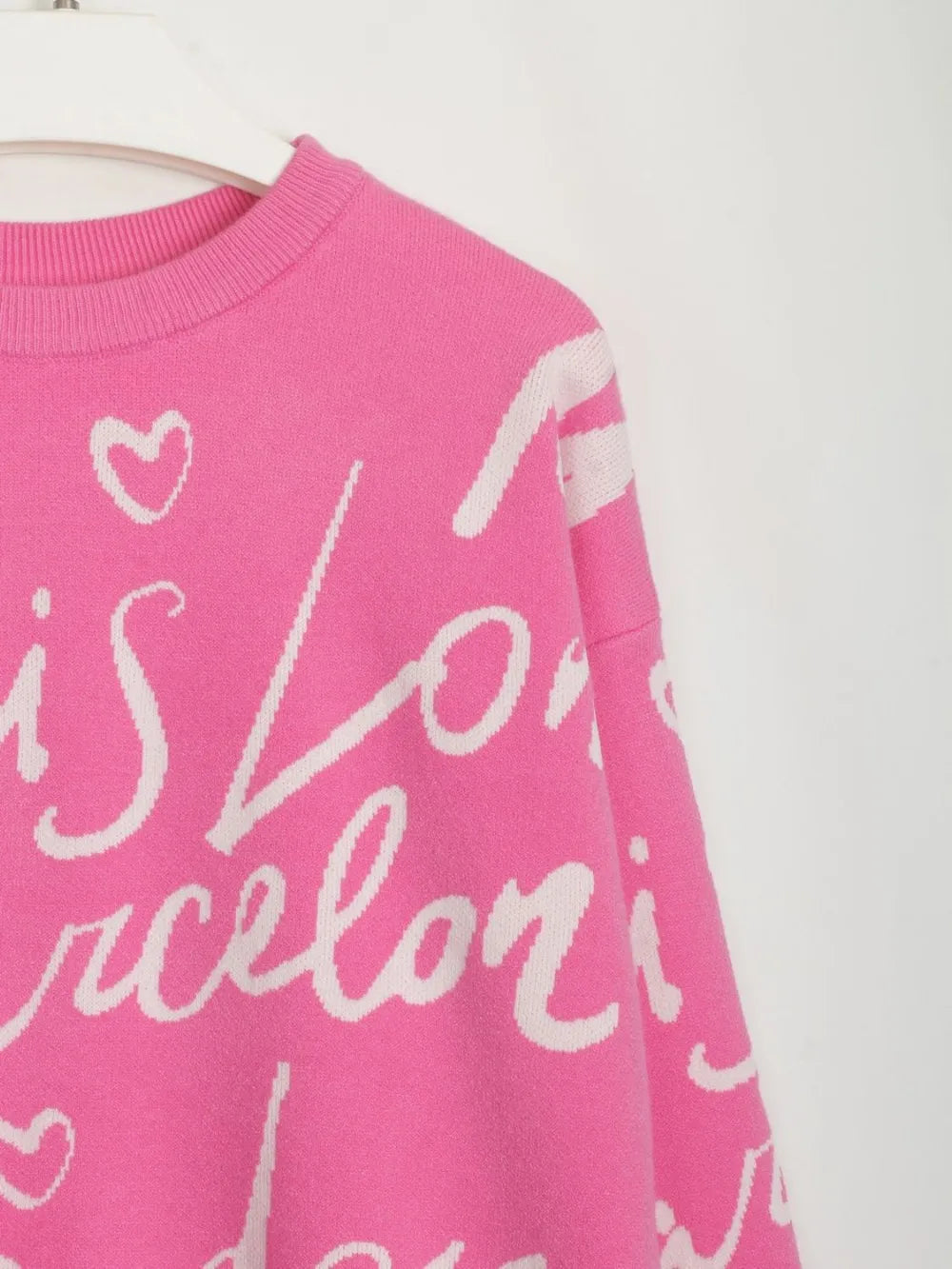 Pink Letter Pattern Sweater with playful white text, featuring a dropped shoulder design and drawstring hem for modern style.
