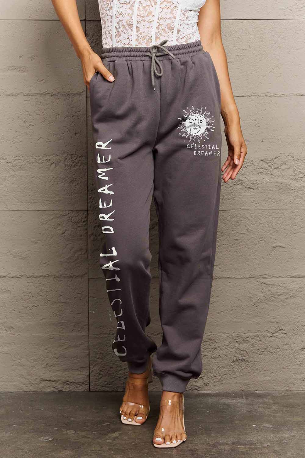 Graphic Sweatpants with CELESTIAL DREAMER print, featuring relaxed fit and drawstring waistband for comfort and style.