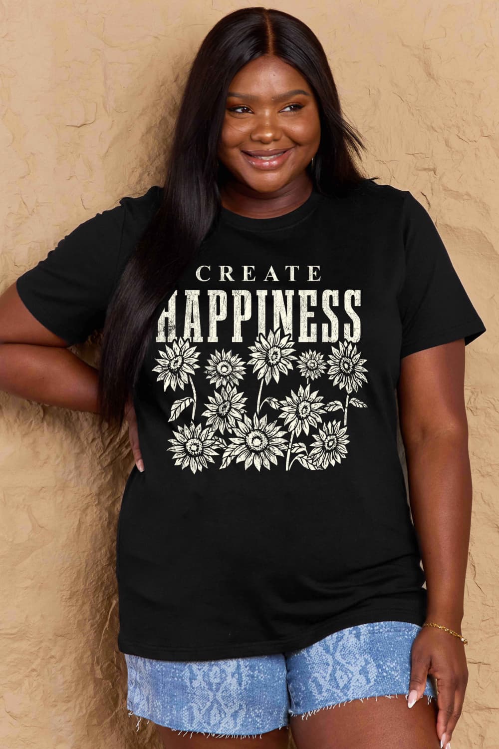 Woman wearing Graphic Cotton T-Shirt with CREATE HAPPINESS print, casual style for a positive vibe.