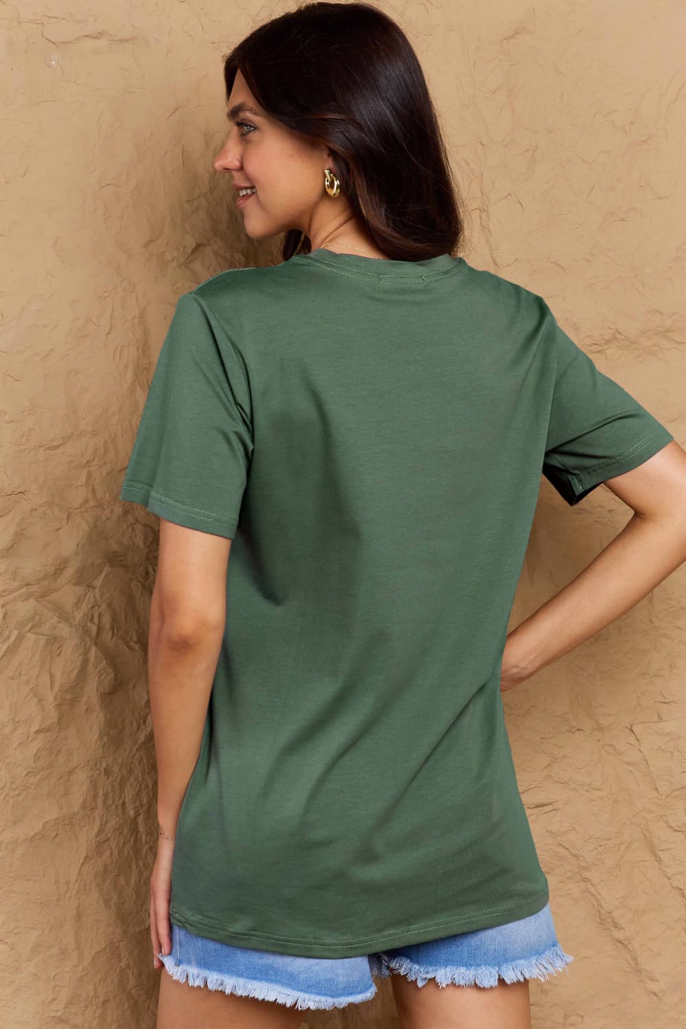 Woman modeling Graphic Cotton T-Shirt with CREATE HAPPINESS print, casual wear, green color, back view, full-size, comfortable fit.