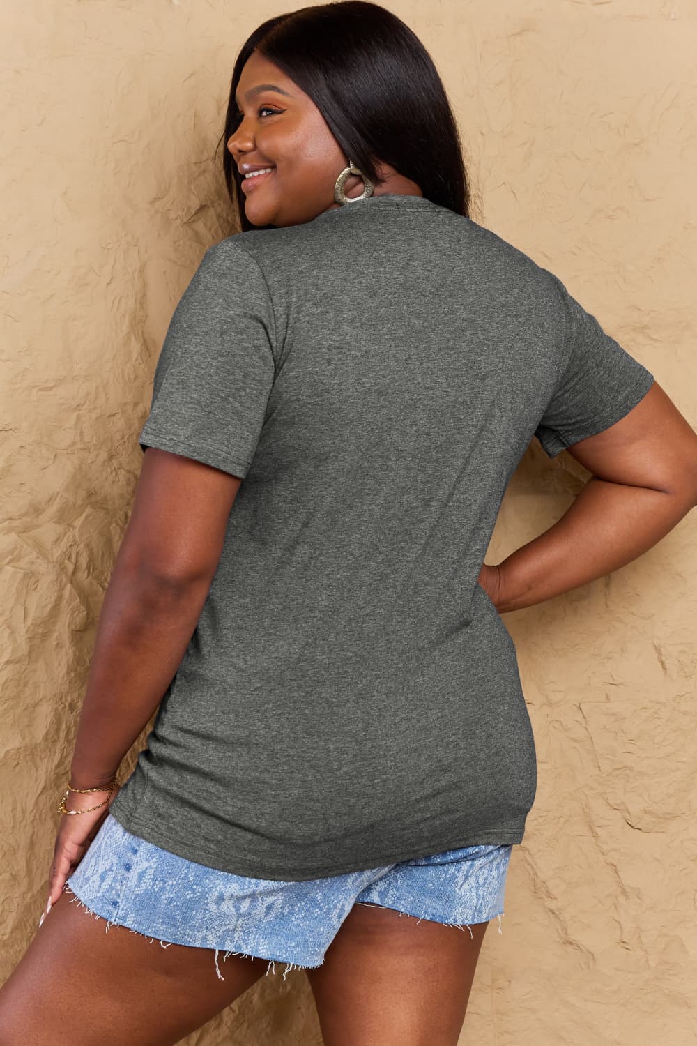 Rear view of woman wearing Graphic Cotton T-Shirt with CREATE HAPPINESS print, showcasing casual style and comfort.