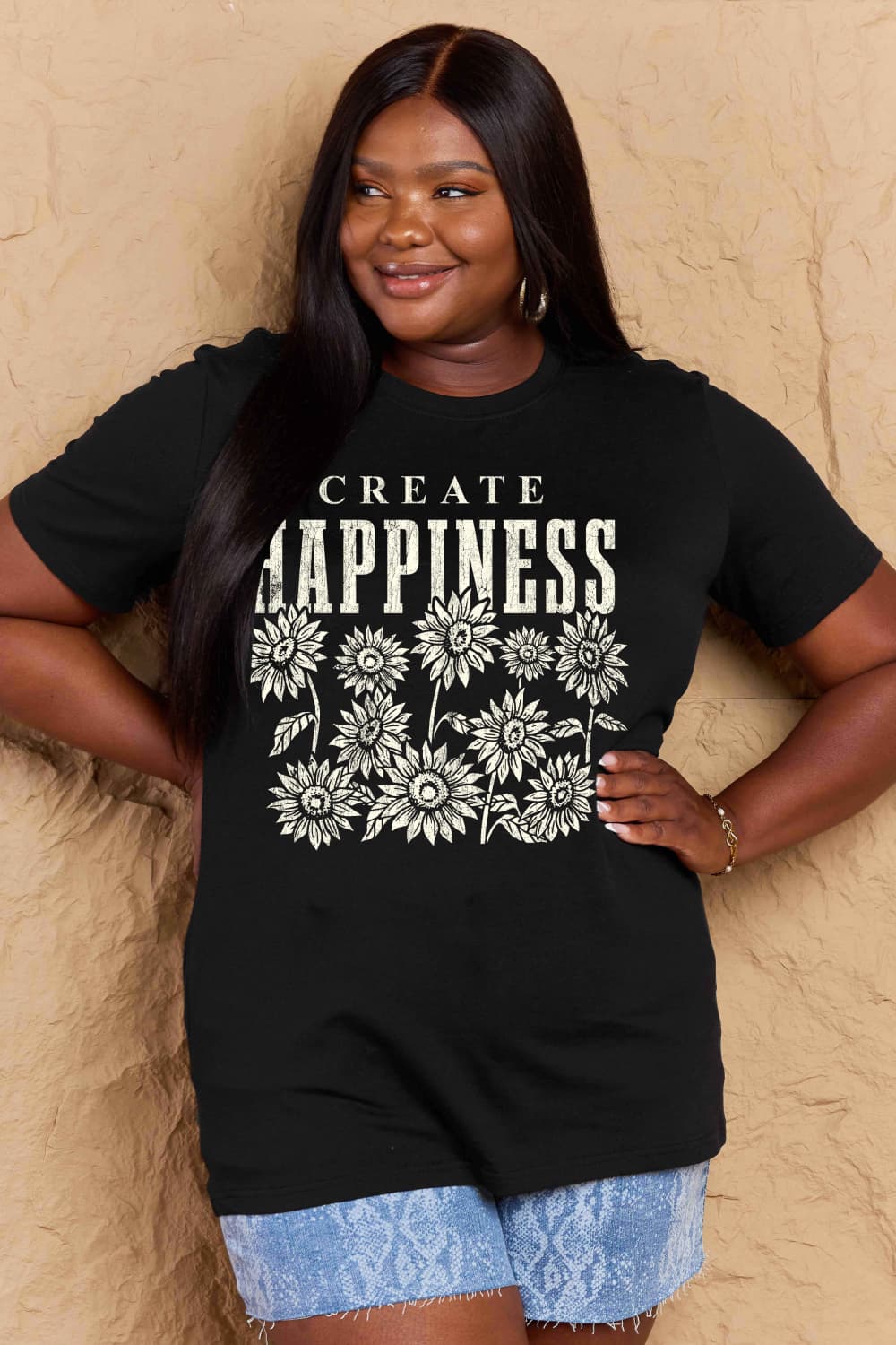 Woman wearing Graphic Cotton T-Shirt with 'CREATE HAPPINESS' print, casual style, full-size fit for everyday wear.