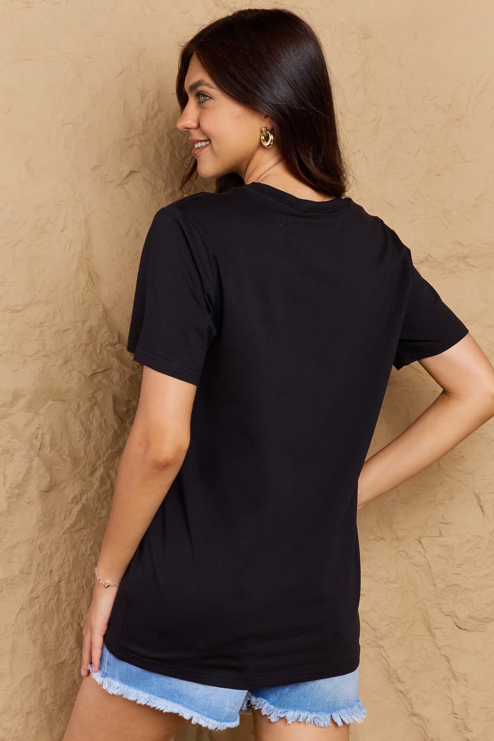 Woman wearing Graphic Cotton T-Shirt with FIND INNER PEACE print, back view for casual style