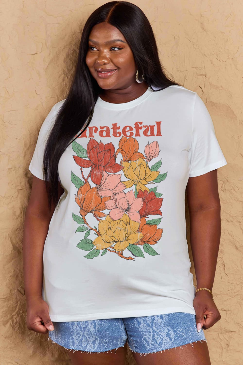 Woman wearing a Graphic Cotton T-Shirt with Grateful flower print design, showcasing positivity and comfort in everyday style.