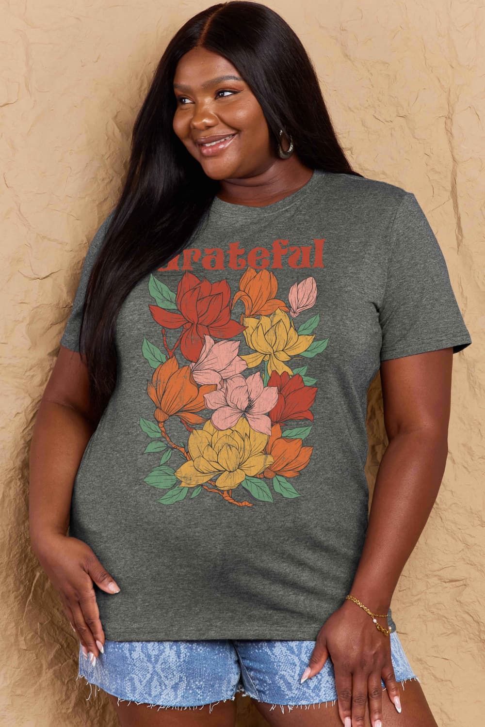 Graphic Cotton T-Shirt with "GRATEFUL" flower print worn by a smiling woman