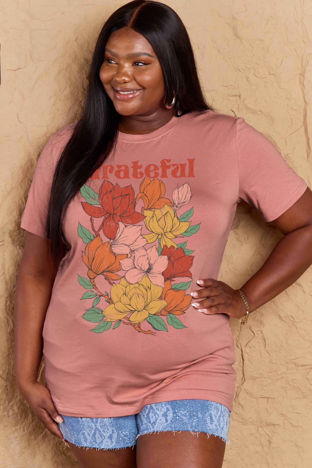 Woman wearing Graphic Cotton T-Shirt with GRATEFUL flower print, full size fit.