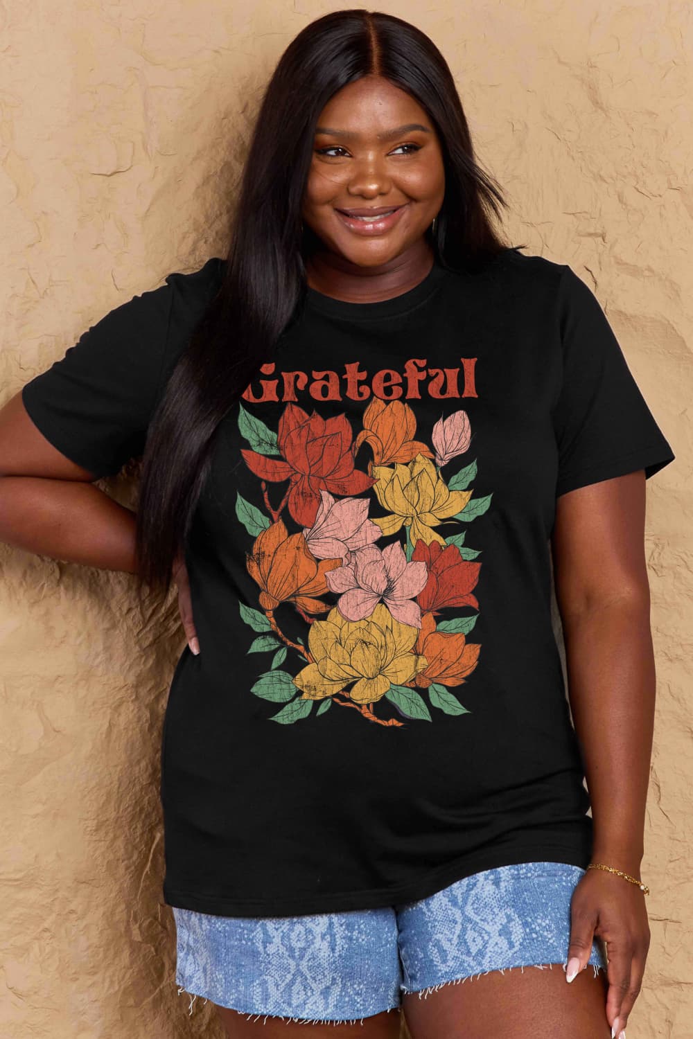 Graphic Cotton T-Shirt with GRATEFUL flower print, full size, worn by a smiling woman