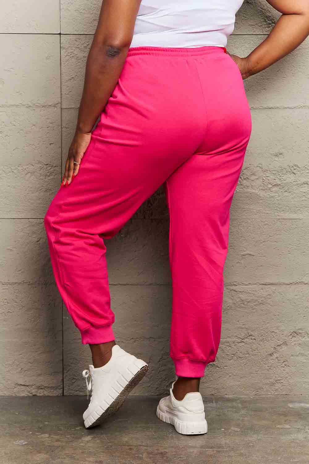 Full-size bright pink Graphic Sweatpants with drawstring waistband, perfect for casual comfort and style.