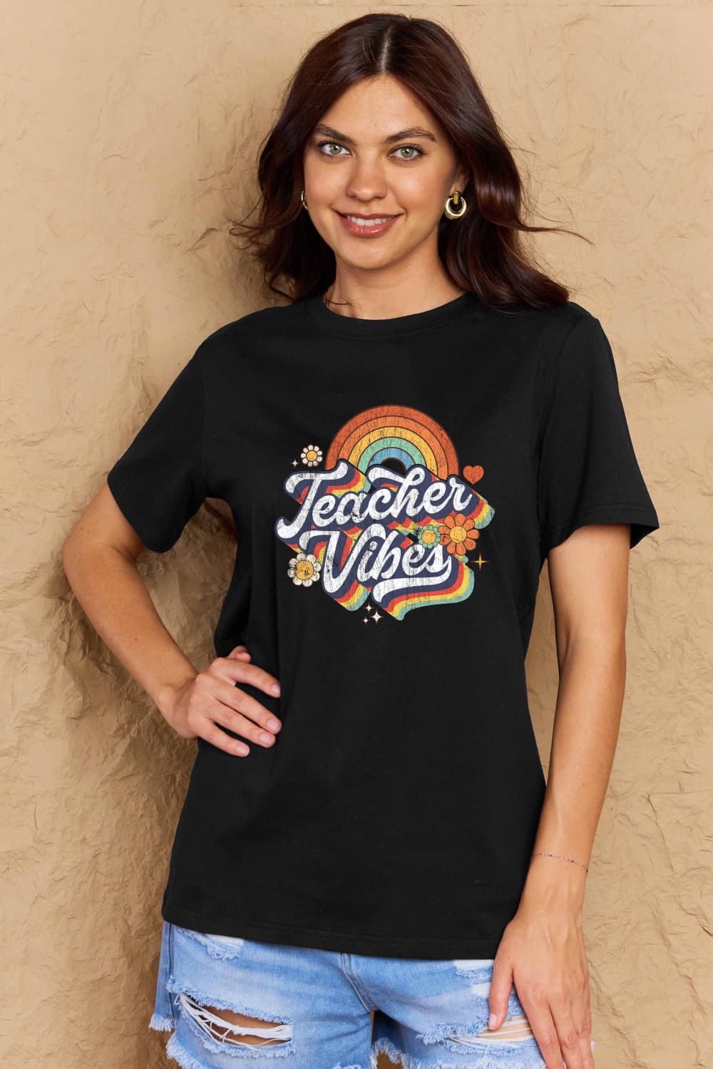 Woman wearing Graphic Cotton T-Shirt with 'TEACHER VIBES' print, casual style for teachers.