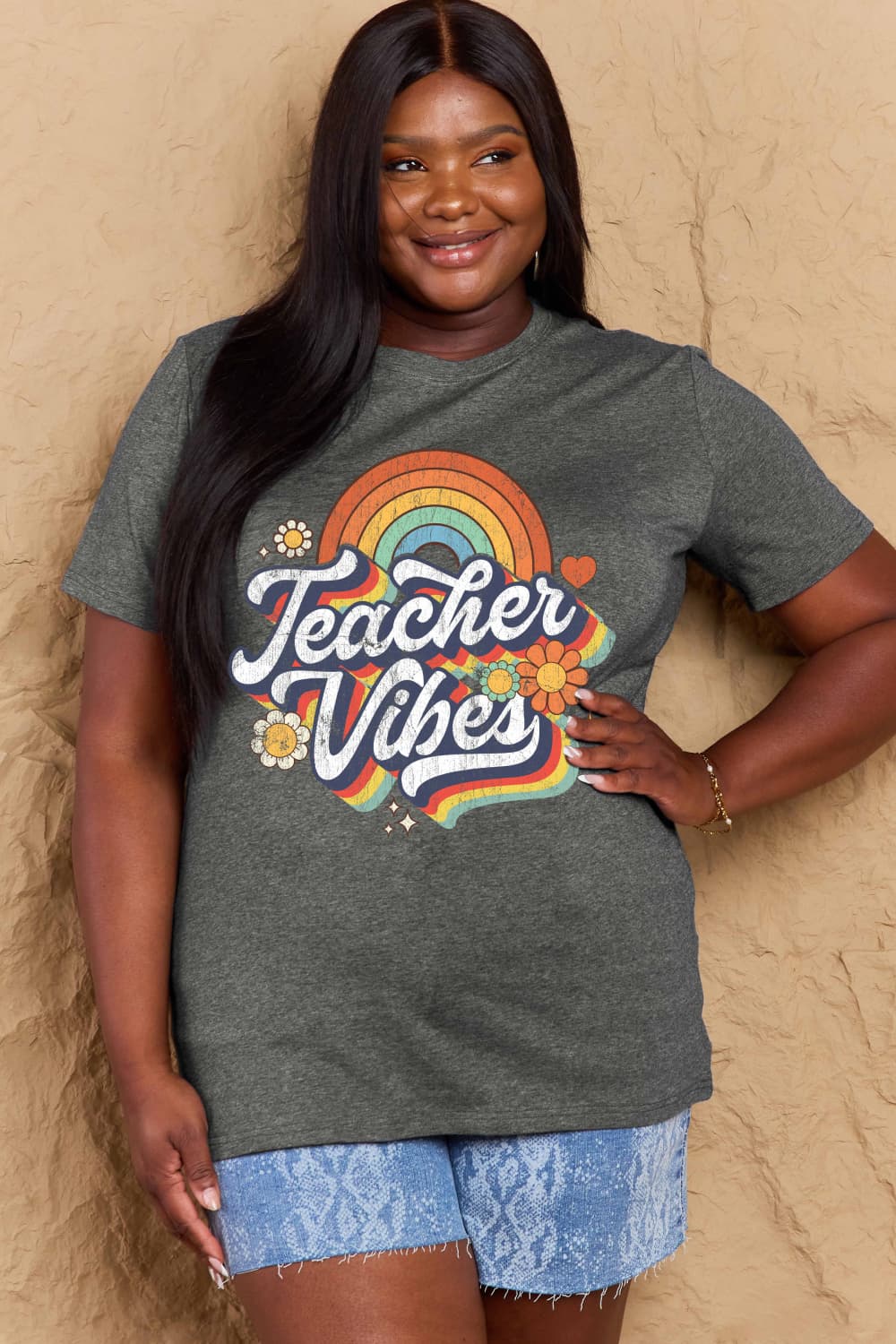 Woman wearing Graphic Cotton T-Shirt with 'TEACHER VIBES' print, showcasing casual style for teachers and self-expression.