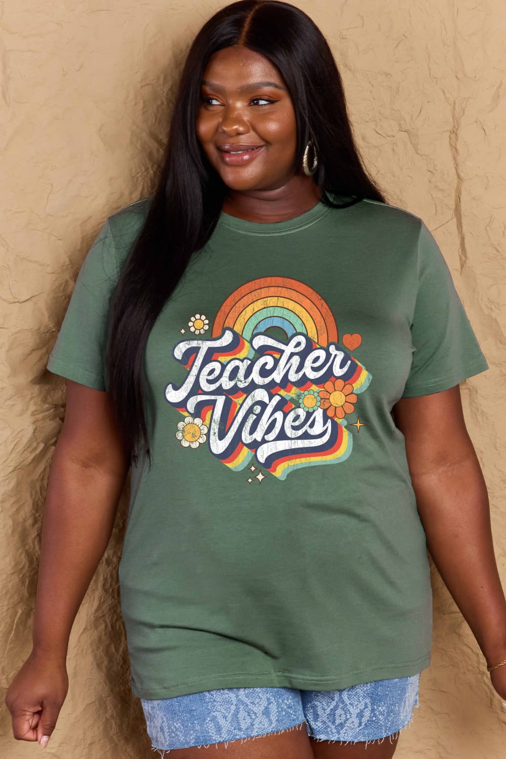 Woman wearing Graphic Cotton T-Shirt with 'TEACHER VIBES' print, featuring a retro design. Ideal for casual and versatile all-day wear.