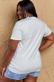 Back view of woman wearing Graphic Cotton T-Shirt with TEACHER VIBES print, showcasing comfort and style for everyday wear.
