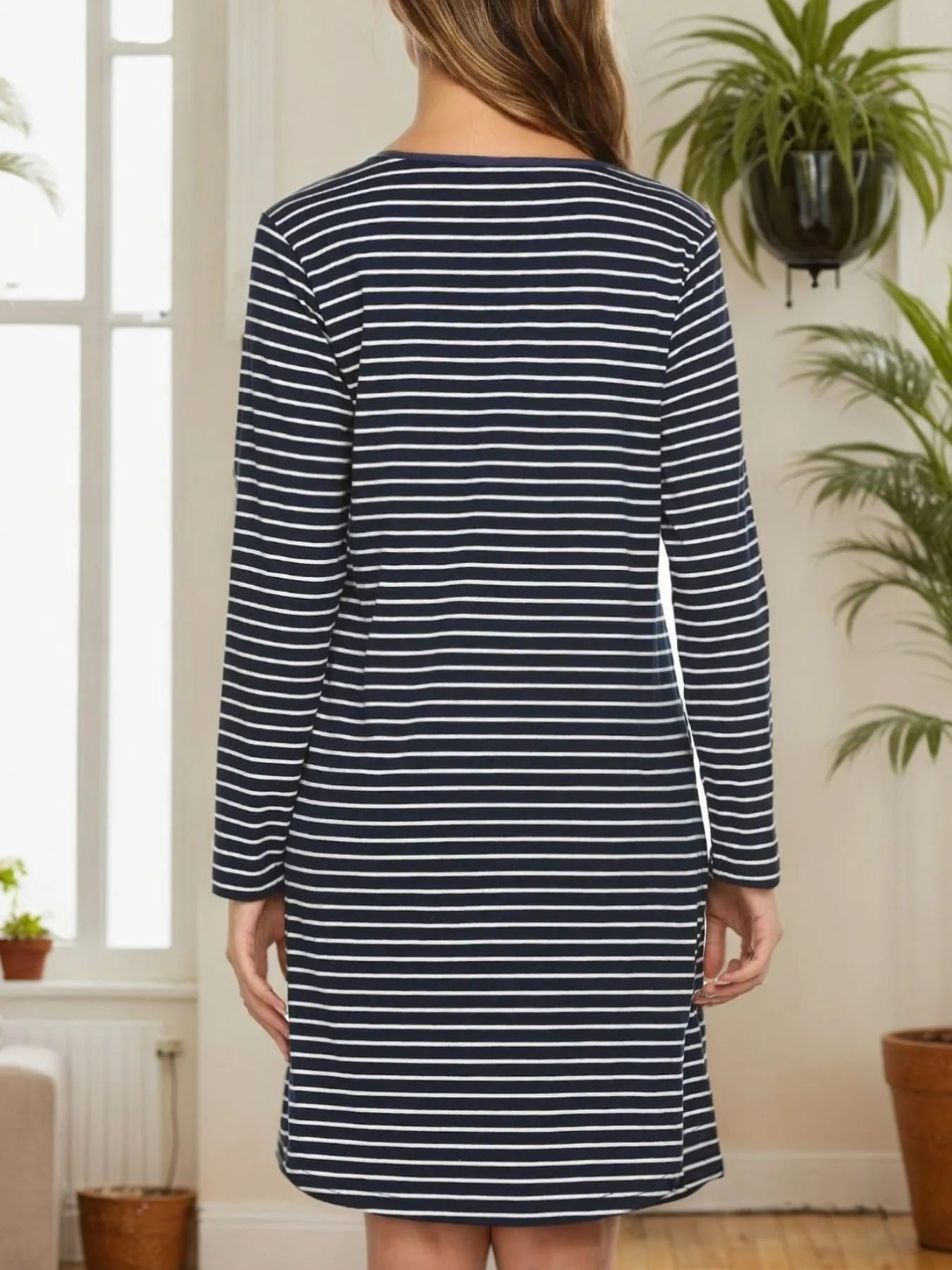 Rear view of Striped Lounge Dress in long sleeve buttoned style, showcasing classic striped pattern in a cozy home setting.