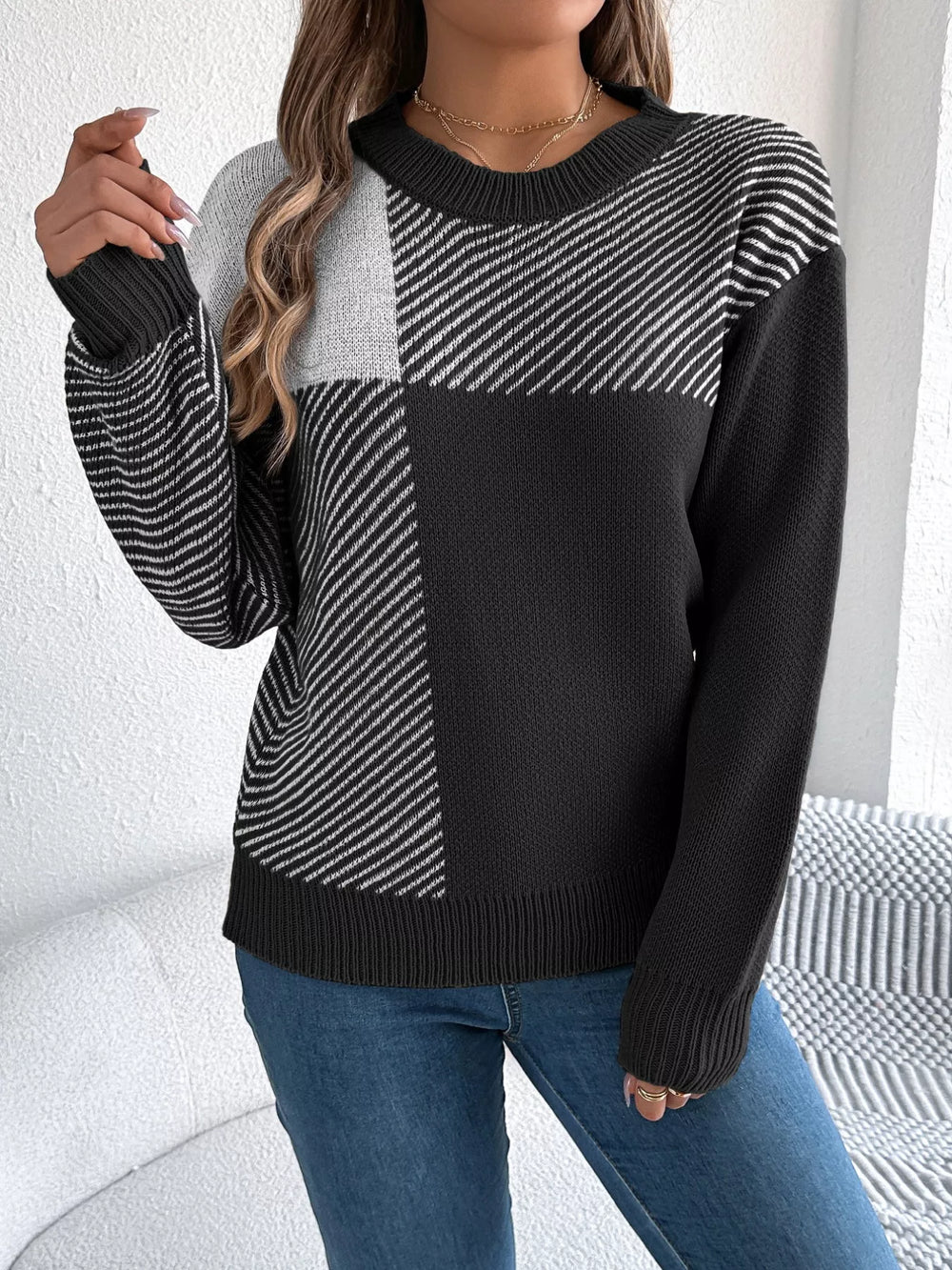 Woman wearing Color Block Striped Sweater with round neck and bold patterns, showcasing casual sophistication and cozy style.